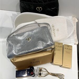 Cle de Peau slippers, eyelash press, lipstick, cosmetic cases and samples